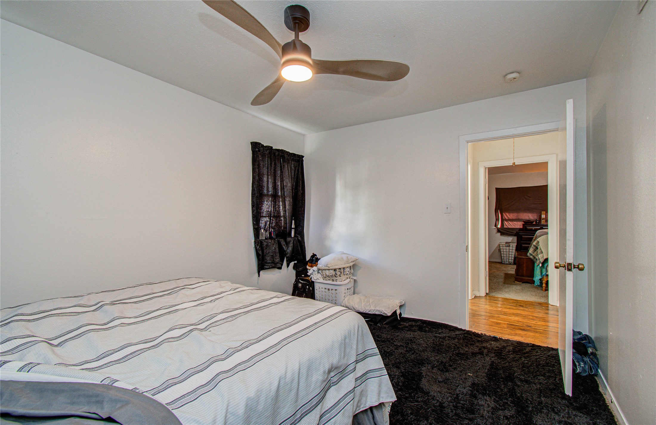 1710 West 11th Street Freeport, TX 77541 - Photo 24 of 34 a bedroom with a bed and a chandelier