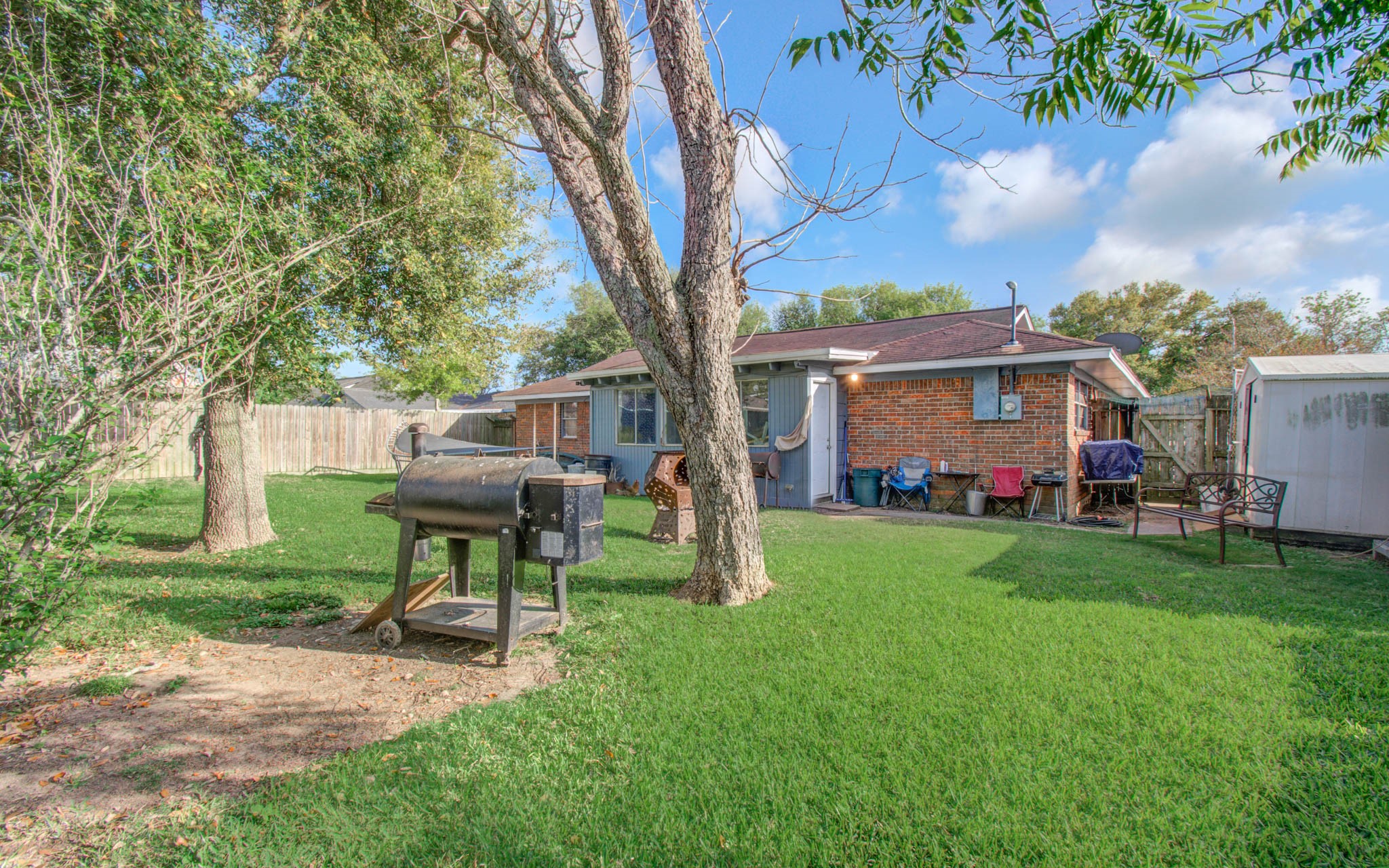 1710 West 11th Street Freeport, TX 77541 - Photo 32 of 34 a view of a house with backyard and a tree