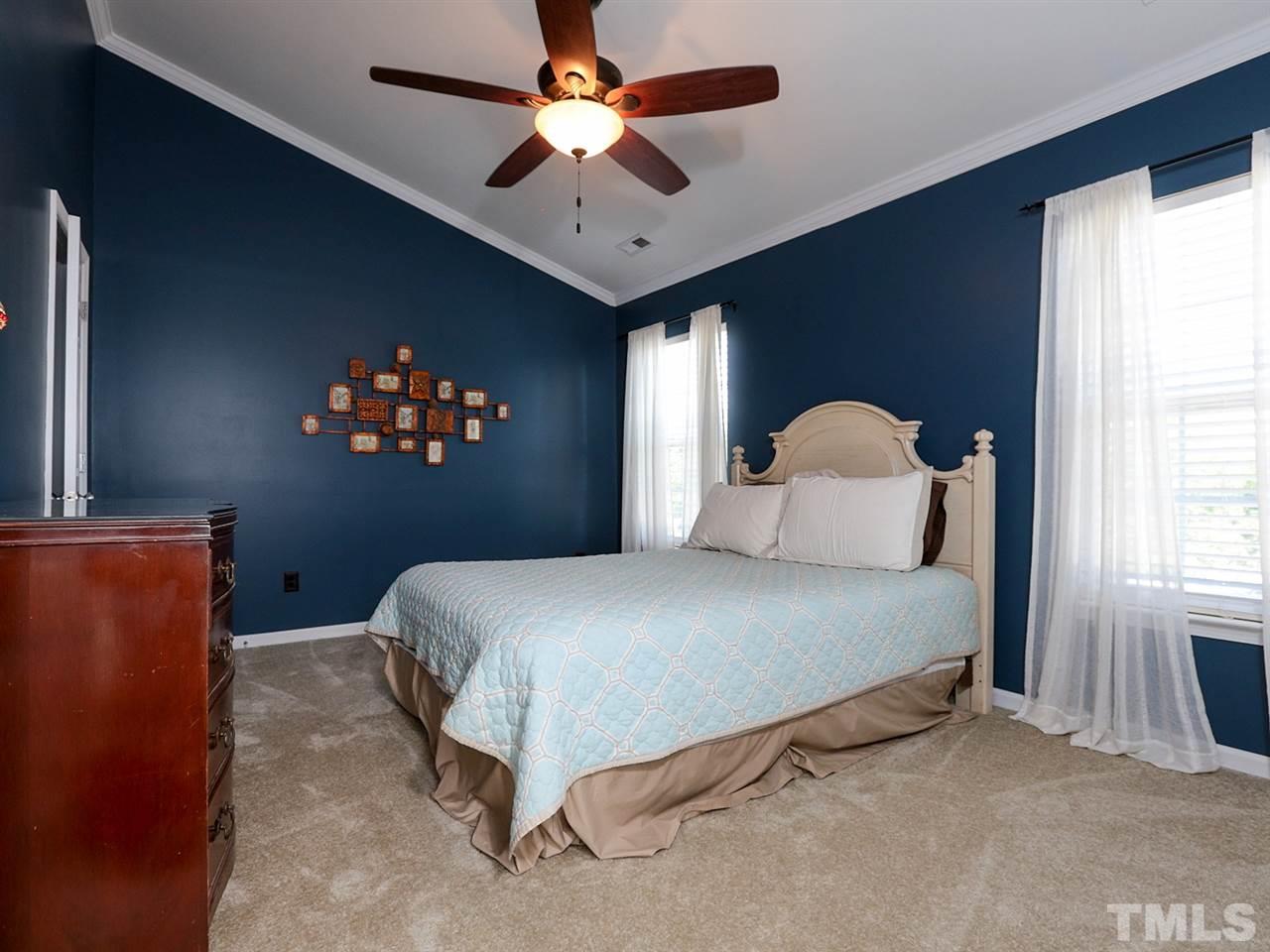 8204 Shadow Stone Court Raleigh, NC 27613 - Photo 12 of 21 a bedroom with a bed and a chandelier
