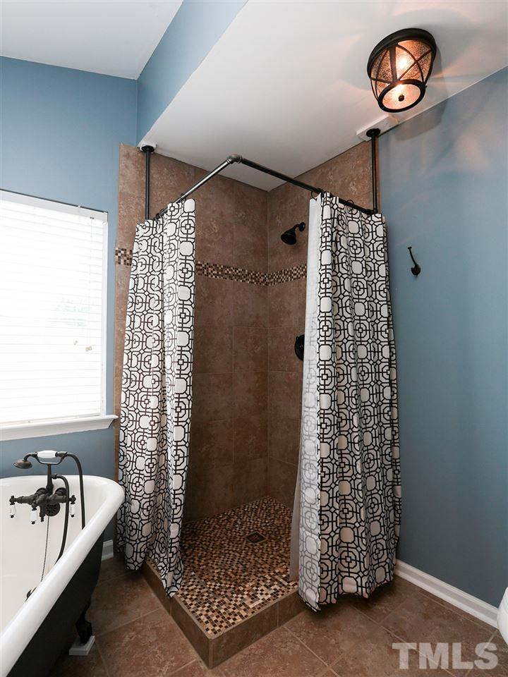 8204 Shadow Stone Court Raleigh, NC 27613 - Photo 13 of 21 a bedroom with a bed and a window