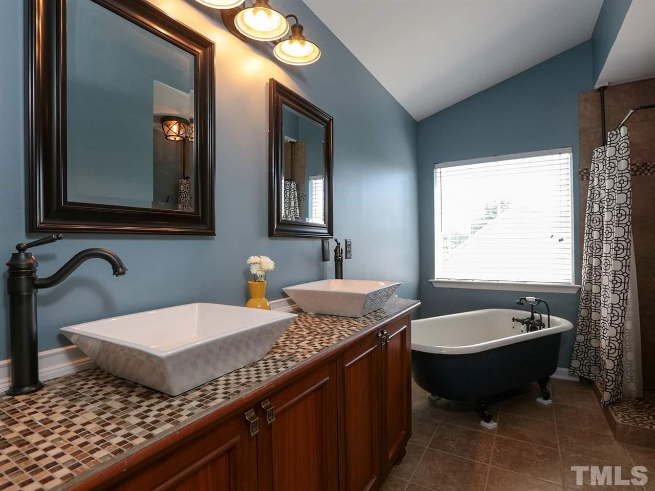 8204 Shadow Stone Court Raleigh, NC 27613 - Photo 14 of 21 a bathroom with a granite countertop sink and a bathtub