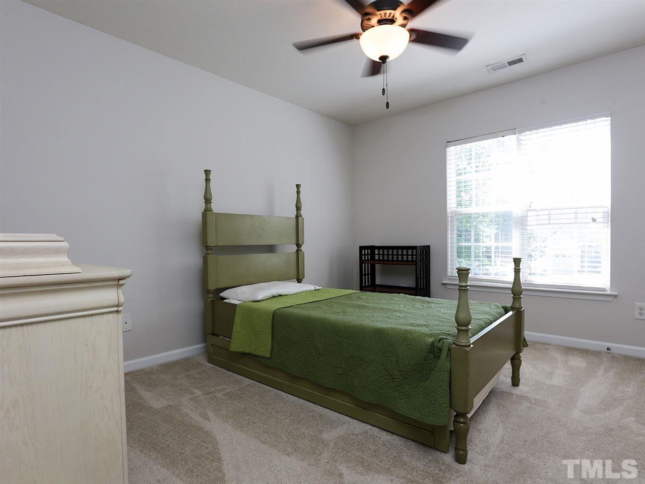 8204 Shadow Stone Court Raleigh, NC 27613 - Photo 15 of 21 a bedroom with a bed and a window