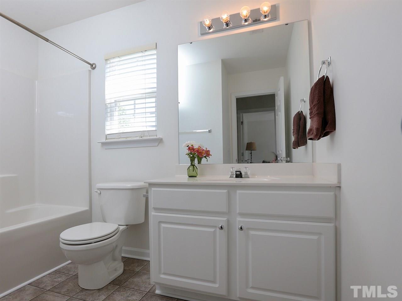 8204 Shadow Stone Court Raleigh, NC 27613 - Photo 17 of 21 a bathroom with a toilet sink and mirror
