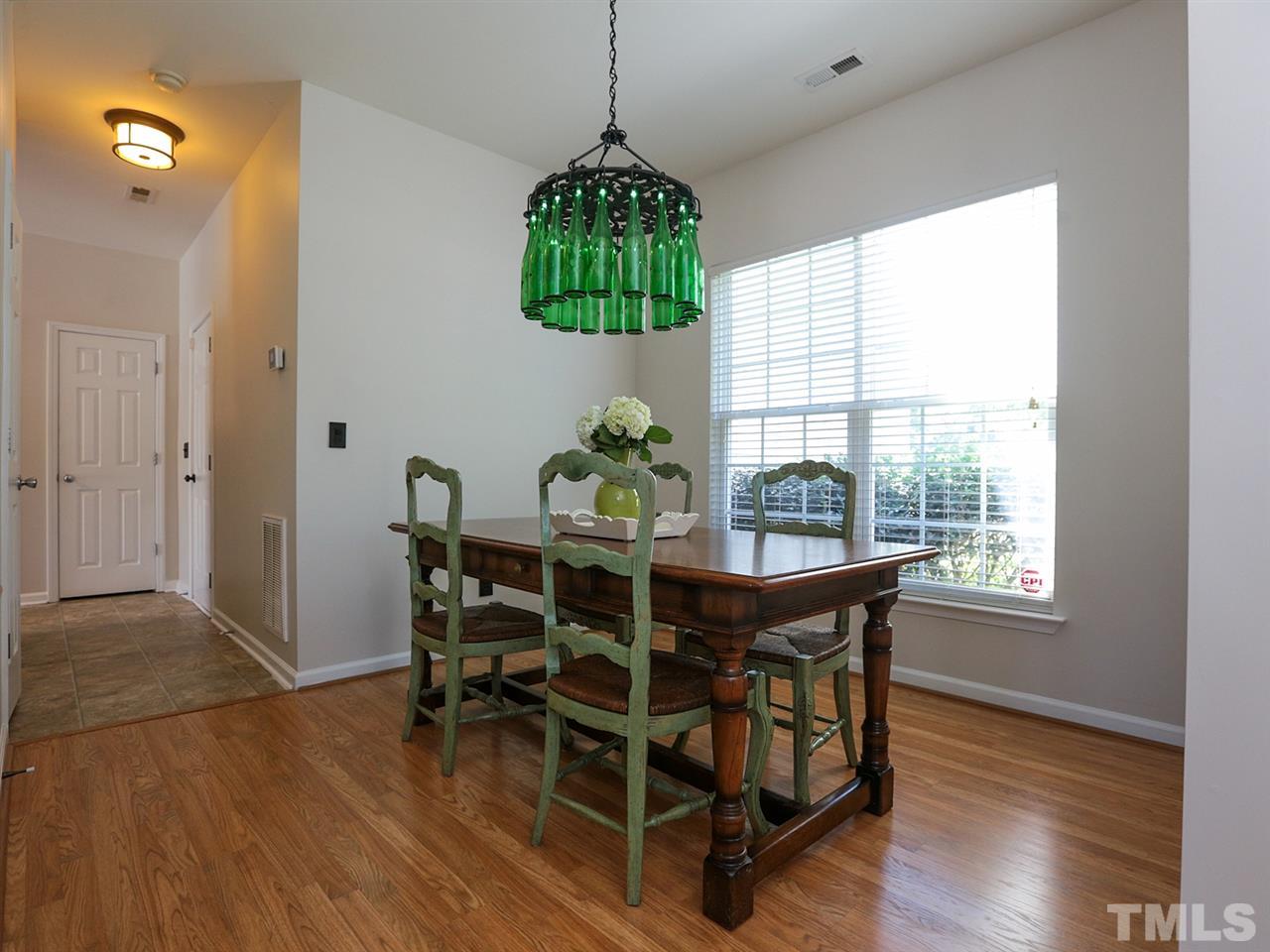 8204 Shadow Stone Court Raleigh, NC 27613 - Photo 4 of 21 a dining room with furniture a chandelier and wooden floor