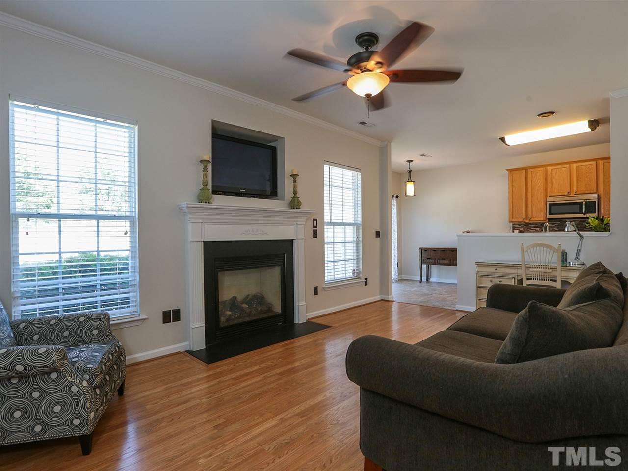 8204 Shadow Stone Court Raleigh, NC 27613 - Photo 5 of 21 a living room with furniture flat screen tv and a fireplace
