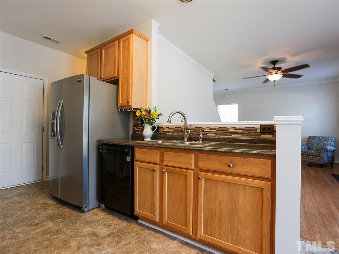 8204 Shadow Stone Court Raleigh, NC 27613 - Photo 9 of 21 a kitchen with stainless steel appliances granite countertop a refrigerator and a sink