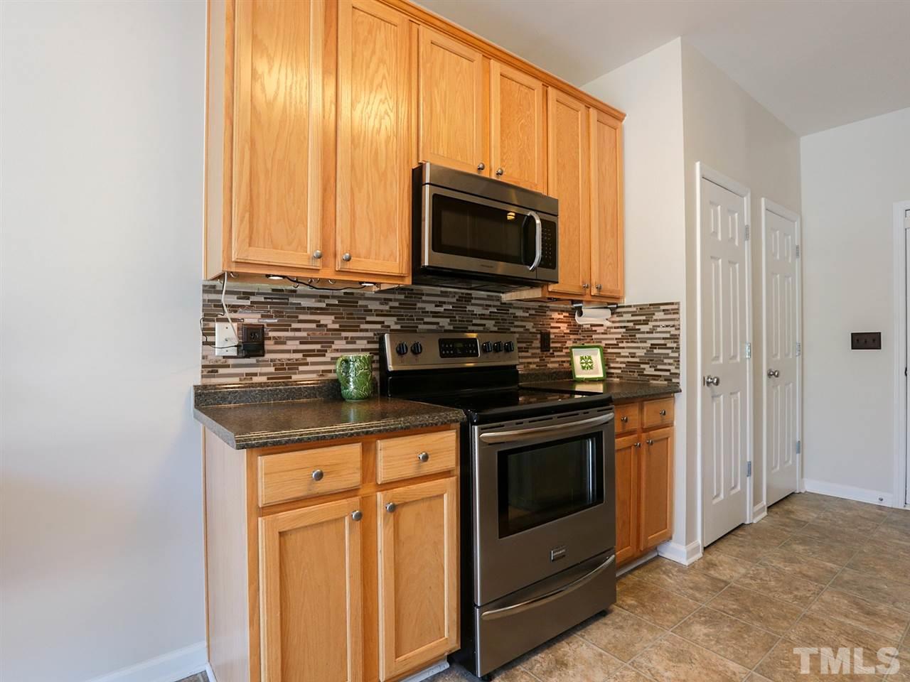 8204 Shadow Stone Court Raleigh, NC 27613 - Photo 10 of 21 a kitchen with stainless steel appliances granite countertop a stove microwave and sink
