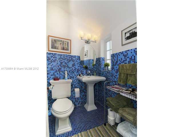 5100 La Gorce Drive Miami Beach, FL 33140 - Photo 16 of 25 a bathroom with a toilet and a mirror