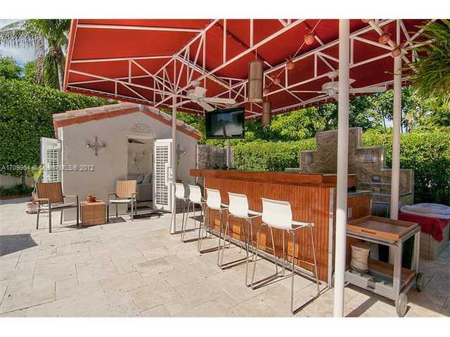 5100 La Gorce Drive Miami Beach, FL 33140 - Photo 20 of 25 a view of a chairs and table in the backyard of a house
