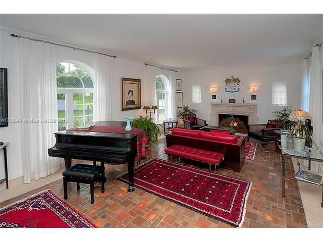 5100 La Gorce Drive Miami Beach, FL 33140 - Photo 4 of 25 a living room with furniture a fireplace and large windows