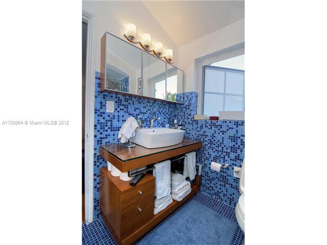 5100 La Gorce Drive Miami Beach, FL 33140 - Photo 9 of 25 a bathroom with a sink and a mirror
