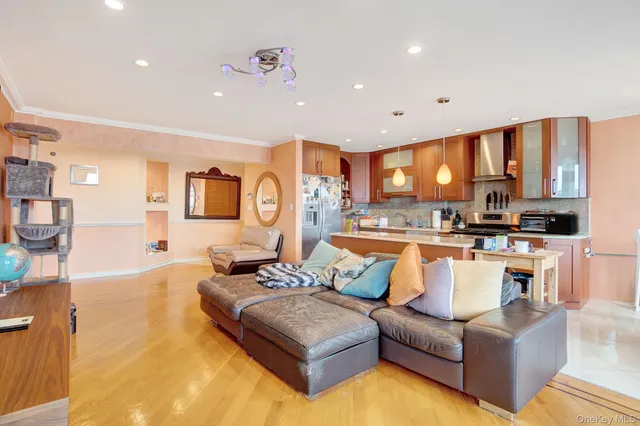 a living room with furniture kitchen area and a table