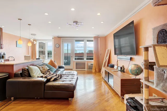 a living room with furniture window and a wooden floor