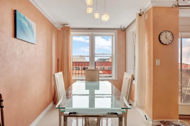 a view of a very nice looking dining room with a table and a large window