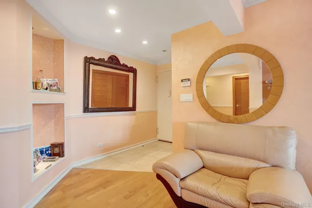 a living room with a couch and a mirror