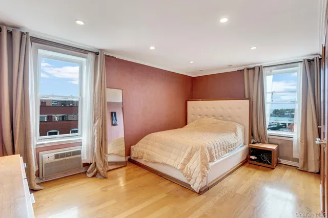 a spacious bedroom with a bed and a window