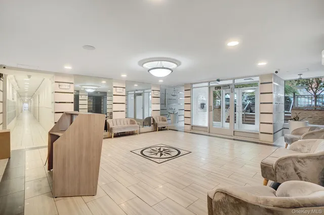 a living room with furniture floor to ceiling window and wooden floor