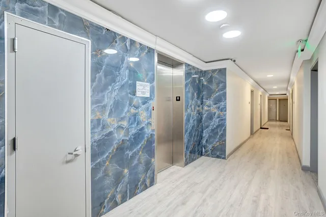 a bathroom with a shower and a glass door