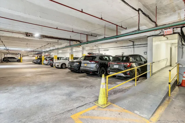 a view of parking garage with cars