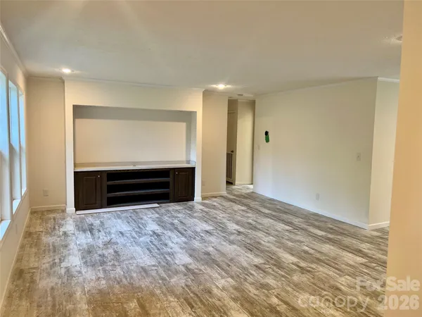 a view of empty room with a fireplace