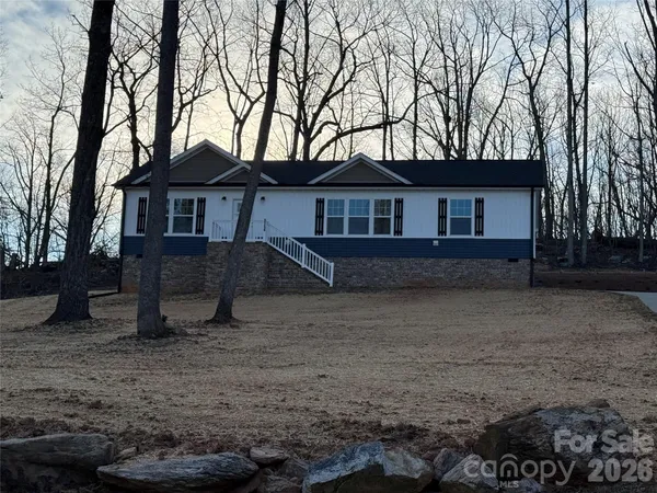 a view of a house with a tree in the yard