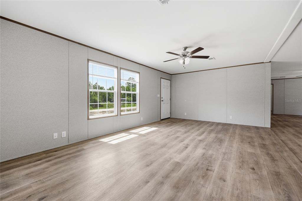 150 19th Street Interlachen, FL 32148 - Photo 11 of 30 wooden floor in an empty room with a window