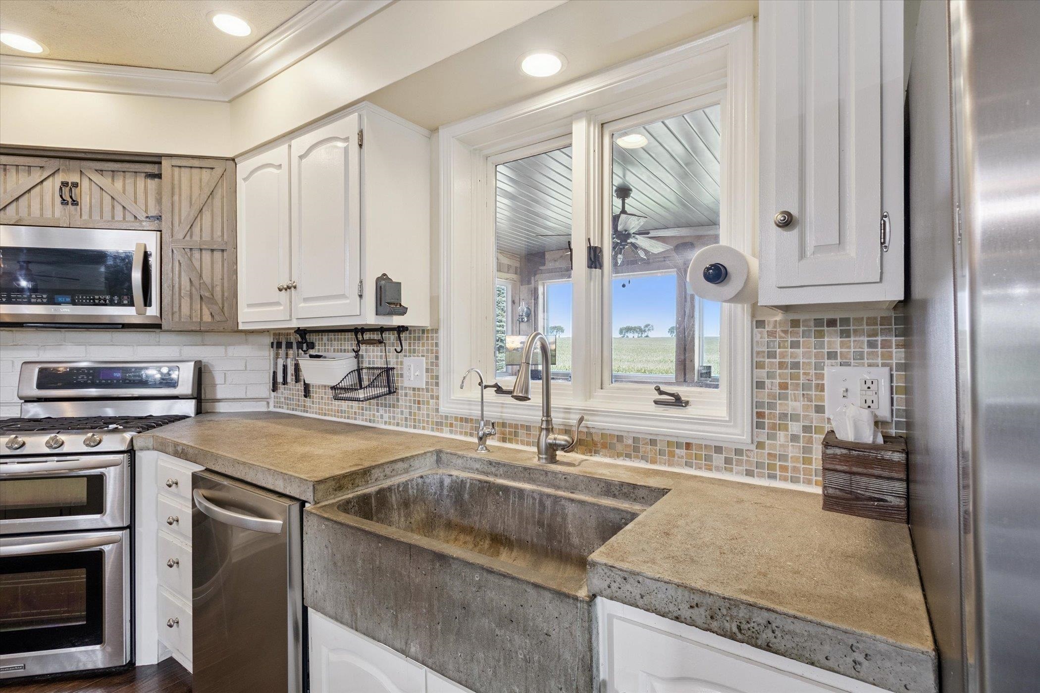 8548 East Edwardsville Road German Valley, IL 61039 - Photo 63 of 70 a kitchen with stainless steel appliances granite countertop a sink a stove and cabinets