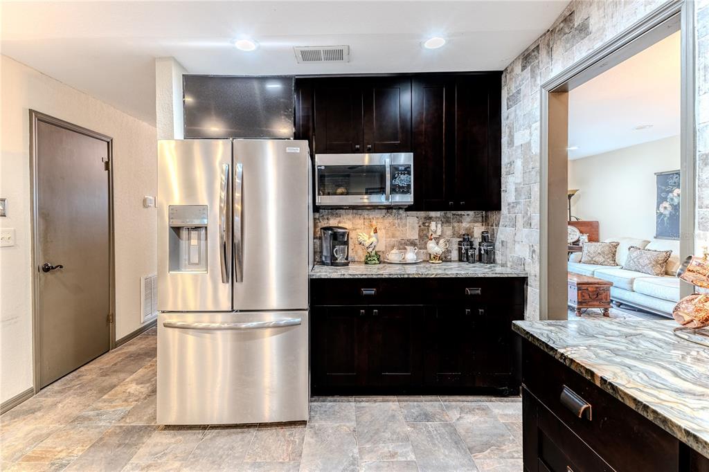 8480 Colma Street Spring Hill, FL 34606 - Photo 24 of 70 a kitchen with stainless steel appliances granite countertop a refrigerator and a sink