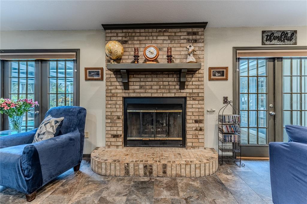 8480 Colma Street Spring Hill, FL 34606 - Photo 30 of 70 a living room with furniture and a fireplace