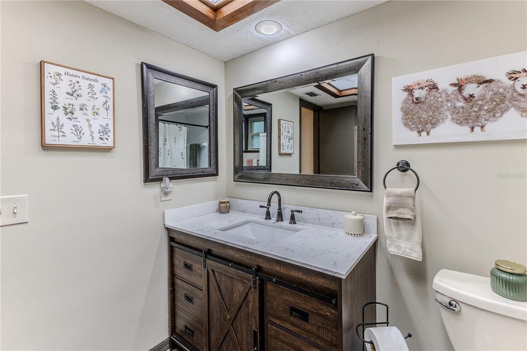 8480 Colma Street Spring Hill, FL 34606 - Photo 37 of 70 a bathroom with a sink and a mirror
