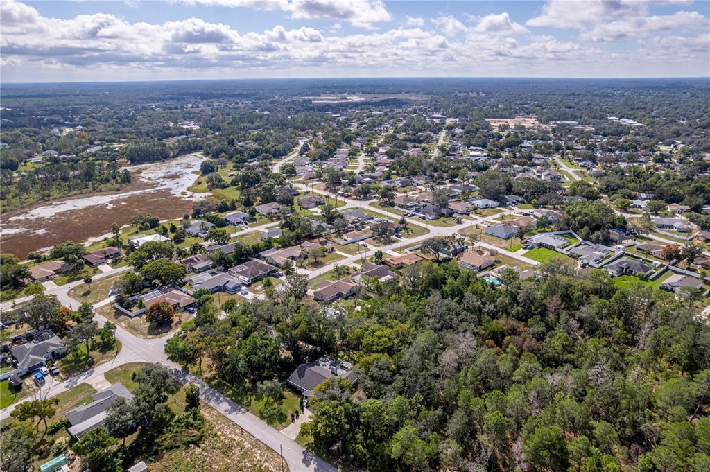 8480 Colma Street Spring Hill, FL 34606 - Photo 38 of 70 an aerial view of residential houses with city and green space