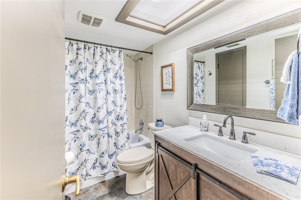 8480 Colma Street Spring Hill, FL 34606 - Photo 40 of 70 a bathroom with a granite countertop sink a toilet and a mirror