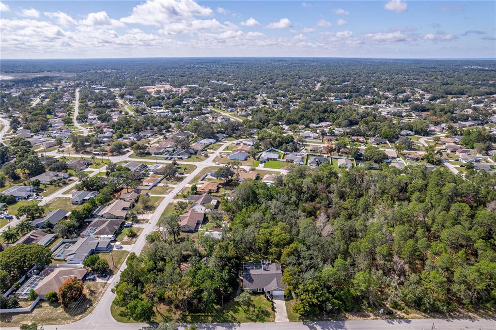 8480 Colma Street Spring Hill, FL 34606 - Photo 42 of 70 an aerial view of residential houses with city view and lake view