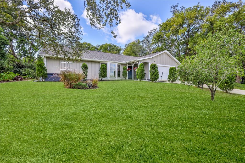 8480 Colma Street Spring Hill, FL 34606 - Photo 69 of 70 a front view of a house with a garden