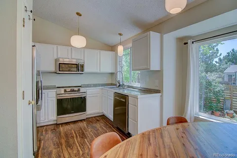 a kitchen with stainless steel appliances a stove a sink and a microwave