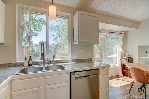 a kitchen with a sink and white cabinets