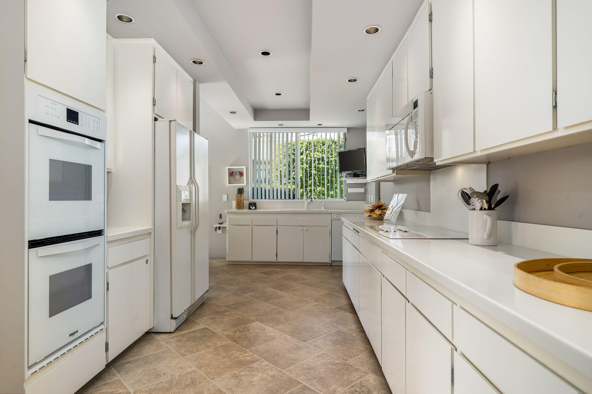 1408 Tamarisk W Street Rancho Mirage, CA 92270 - Photo 20 of 43 a kitchen with a sink stainless steel appliances and cabinets