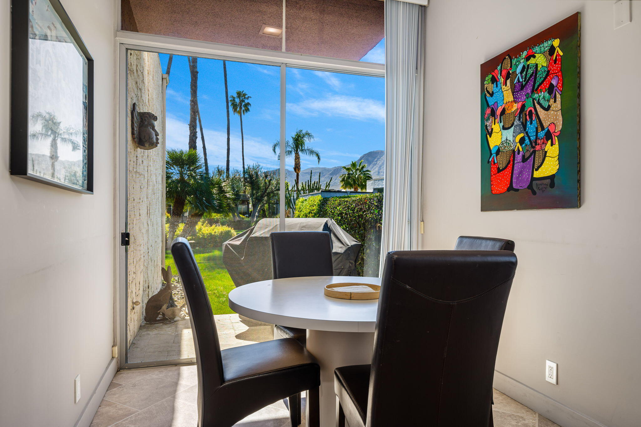 1408 Tamarisk W Street Rancho Mirage, CA 92270 - Photo 23 of 43 a view of a dining room with furniture one side kitchen view and wooden floor