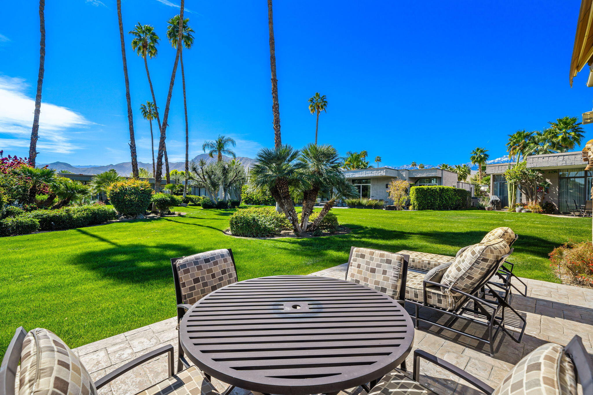 1408 Tamarisk W Street Rancho Mirage, CA 92270 - Photo 29 of 43 a view of a patio with a table chairs and a garden
