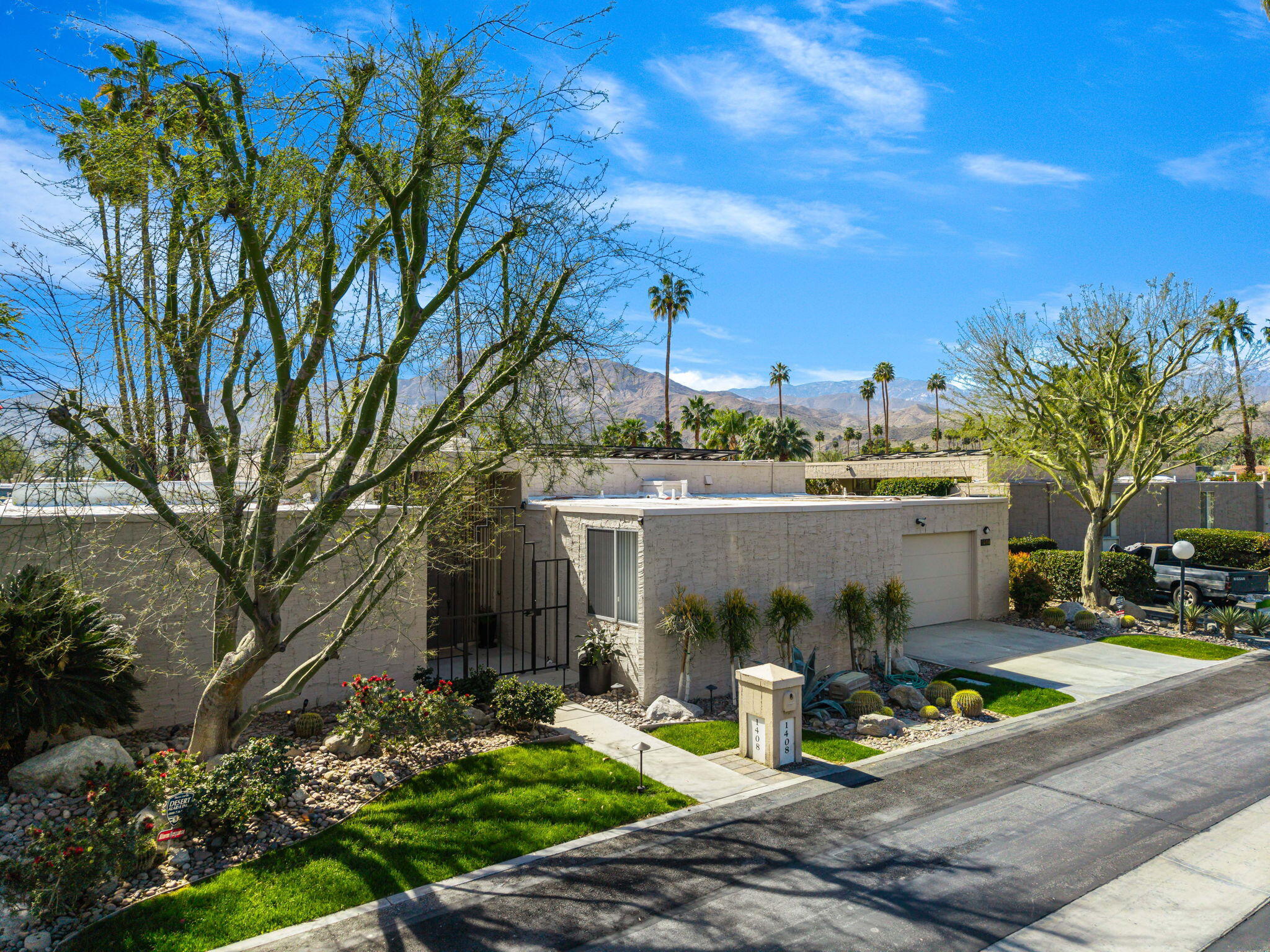 1408 Tamarisk W Street Rancho Mirage, CA 92270 - Photo 3 of 43 a view of a water fountain in front of the house