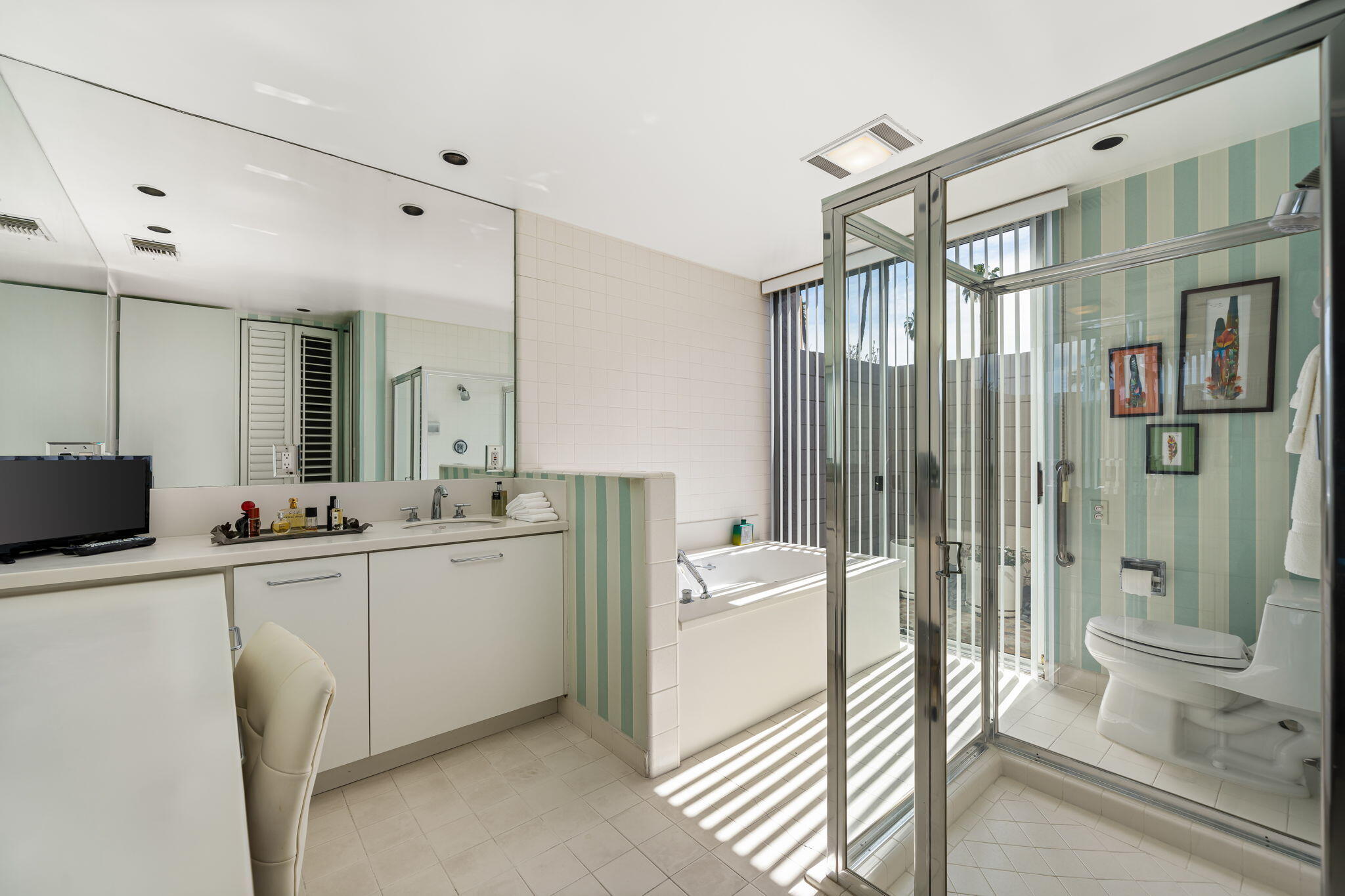 1408 Tamarisk W Street Rancho Mirage, CA 92270 - Photo 32 of 43 a bathroom with a double vanity sink toilet and shower