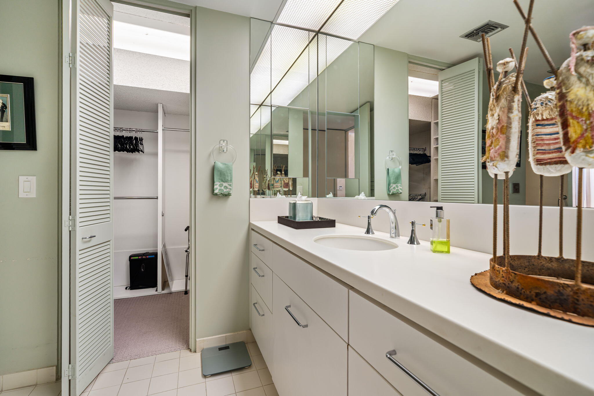 1408 Tamarisk W Street Rancho Mirage, CA 92270 - Photo 35 of 43 a bathroom with a sink and a mirror