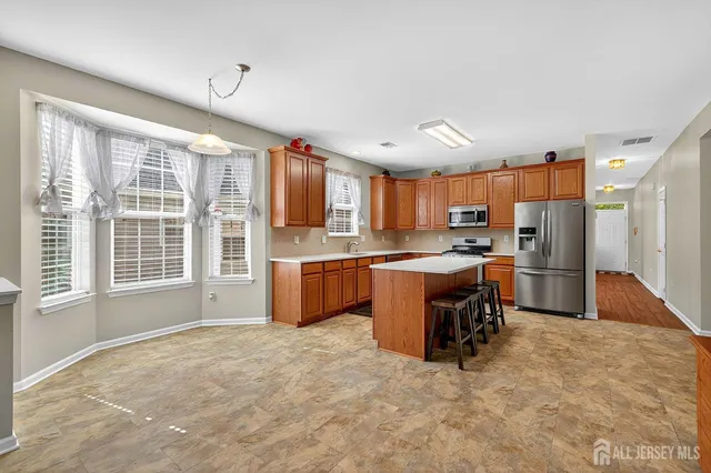 a large kitchen with cabinets and a table