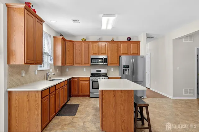 an open kitchen with cabinets and stainless steel appliances