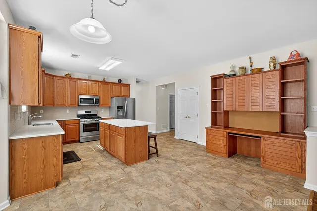 a kitchen with a refrigerator and a sink