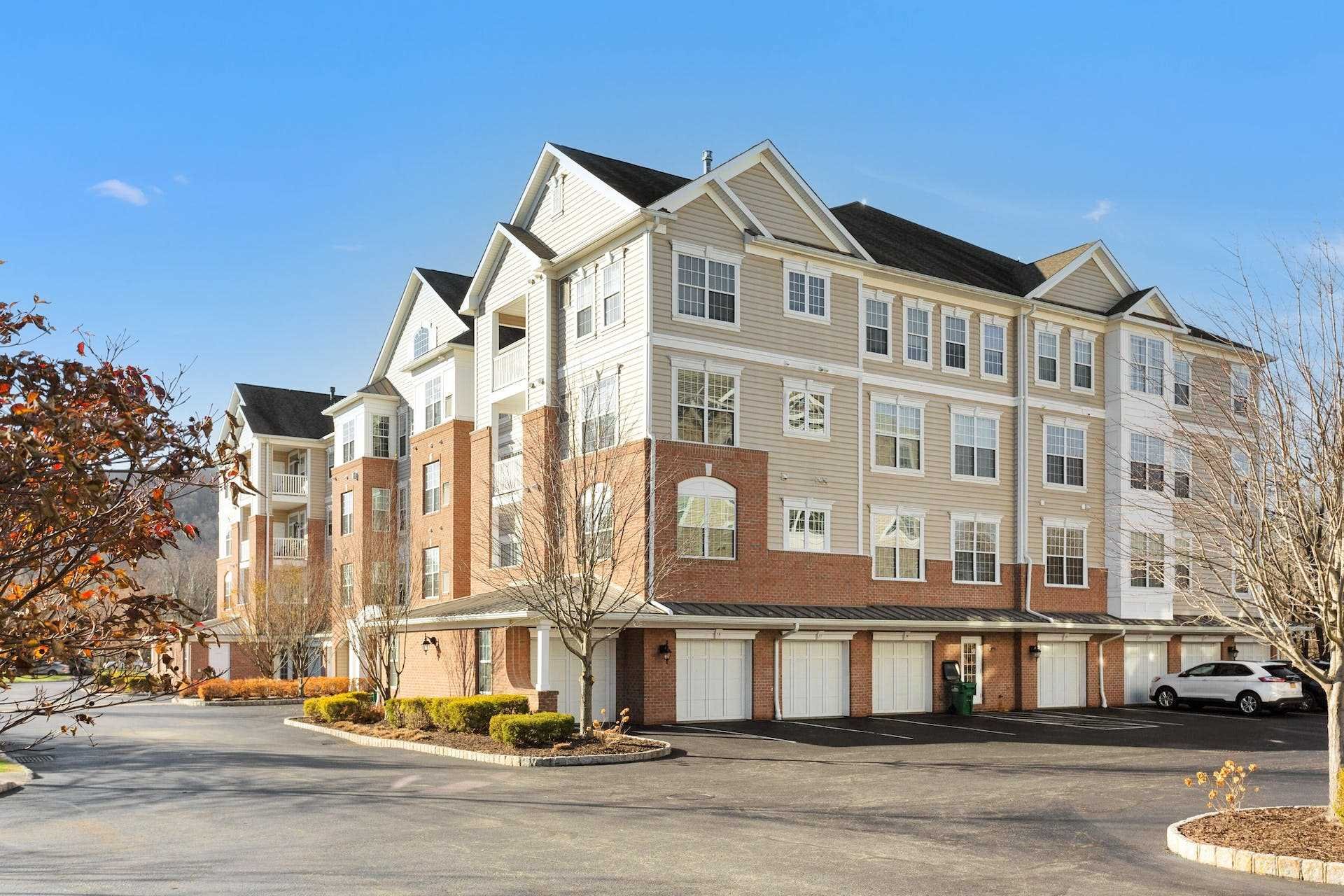 a front view of a building with lot of cars