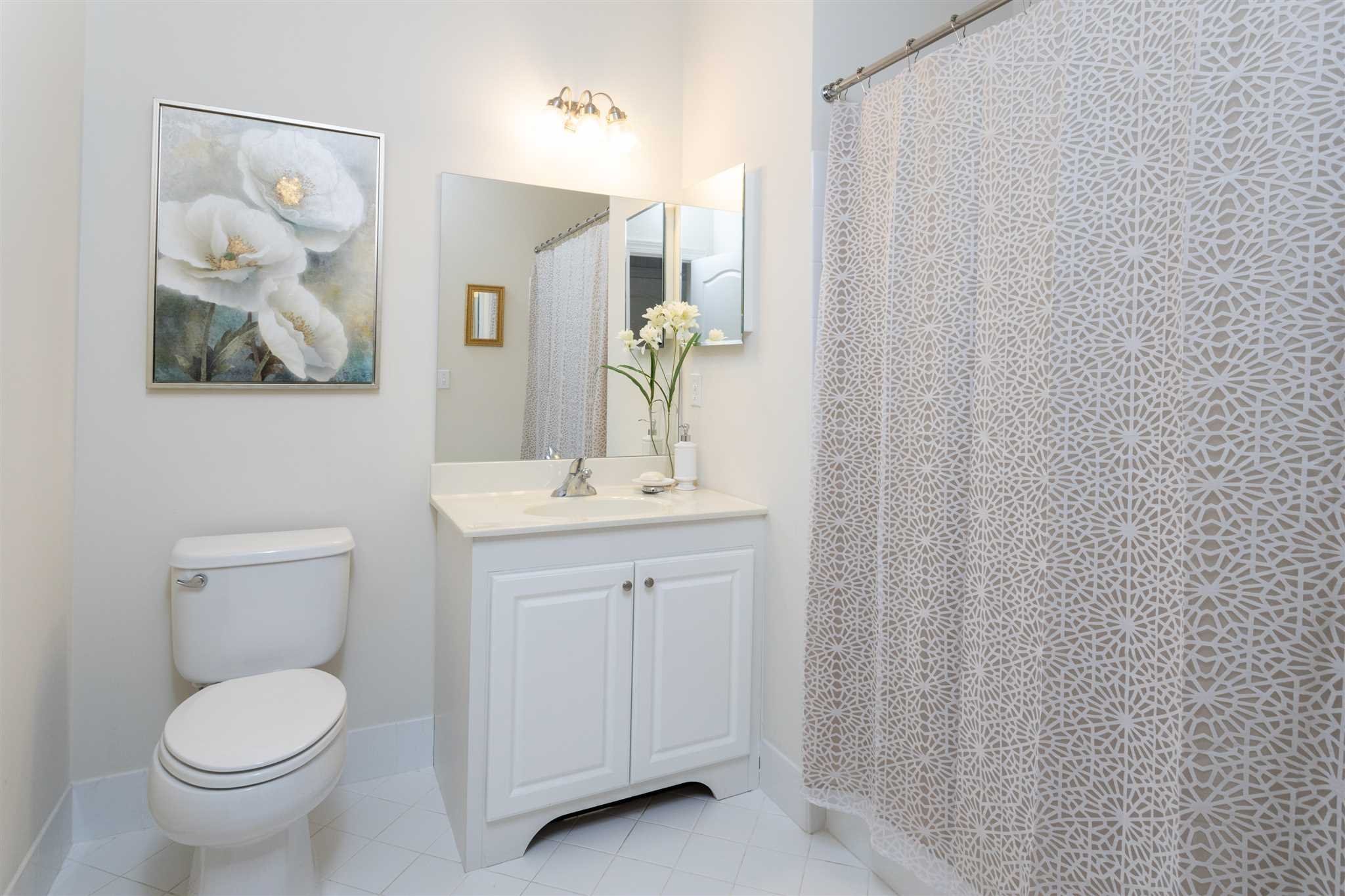 224 Regency Drive, Unit 224 Fishkill, NY 12524 - Photo 25 of 30 a bathroom with a toilet a sink and mirror