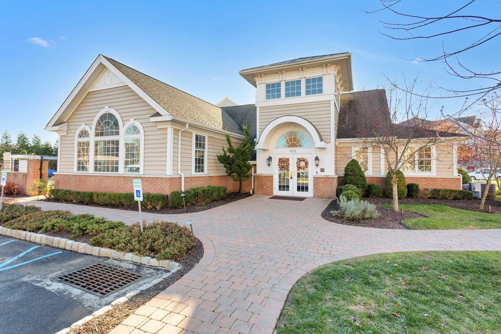 224 Regency Drive, Unit 224 Fishkill, NY 12524 - Photo 8 of 30 a front view of a house with a yard and porch