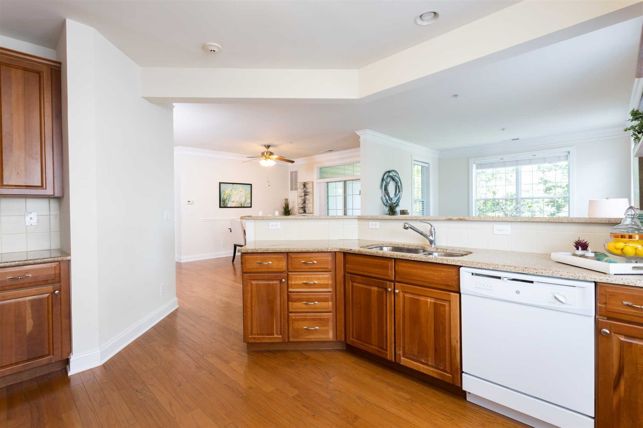 224 Regency Drive, Unit 224 Fishkill, NY 12524 - Photo 10 of 30 a kitchen with stainless steel appliances granite countertop a sink and cabinets
