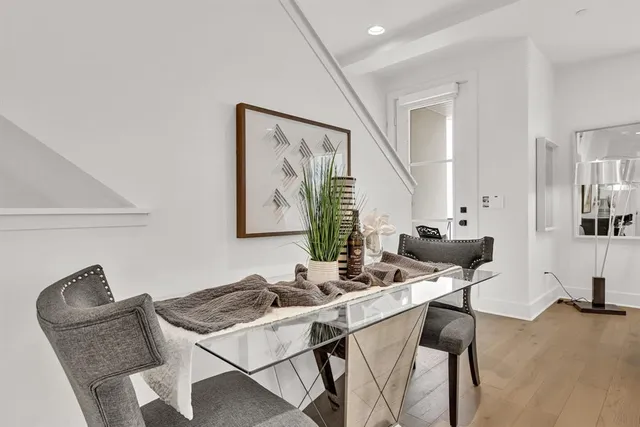 a living room with furniture a large window and kitchen view